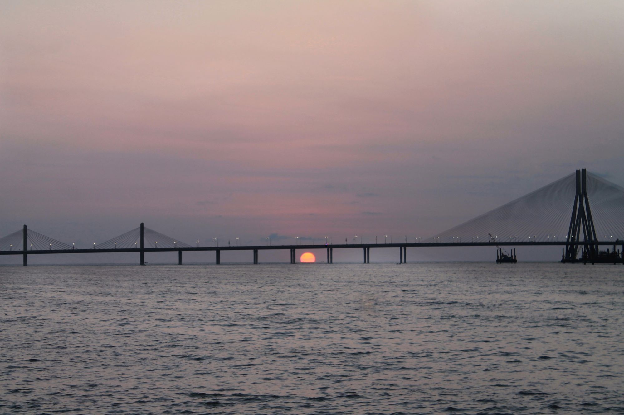 Sunset over the sea with the Bandra-Worli Sea Link on the horizon